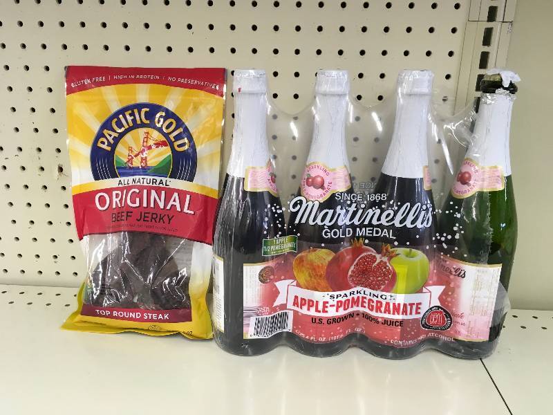 lot 52 image: MARTINELLI APPLEPOM 4 PK, ONE OPEN. RETAIL $8.49 AND PG ORIG BEEF JERKY 8 OZ, RETAIL $15.99