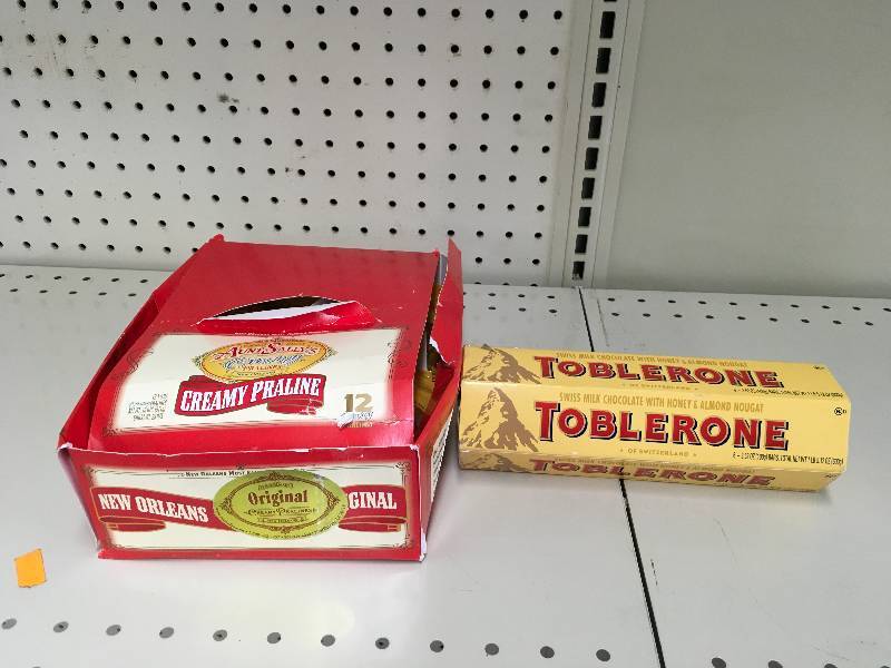 lot 64 image: AUNT SALLYS ORIG PRALINE, RETAIL$14.99 AND TOBLERONE MCHOC 63.52Z, RETAIL $7.49