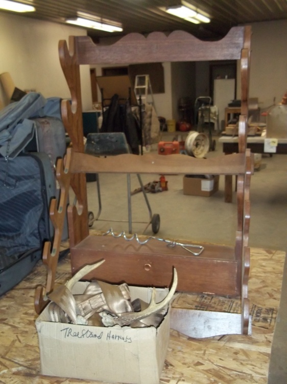 lot 35 image: 2 Gun racks, deer antlers and tree stand harness