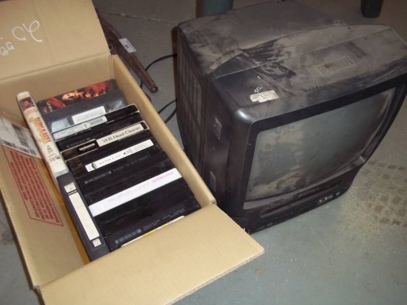 lot 74 image: TV with VHS Player and VHS Tapes