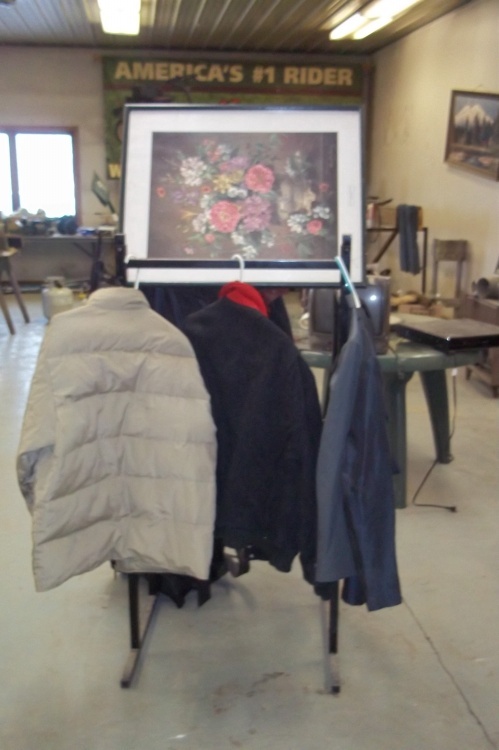 lot 106 image: Coat rack with coats and picture