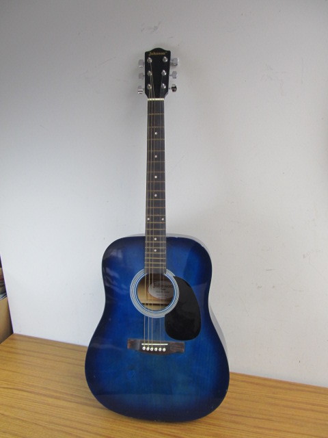 lot 10 image: Blue Acoustic Johnson Guitar