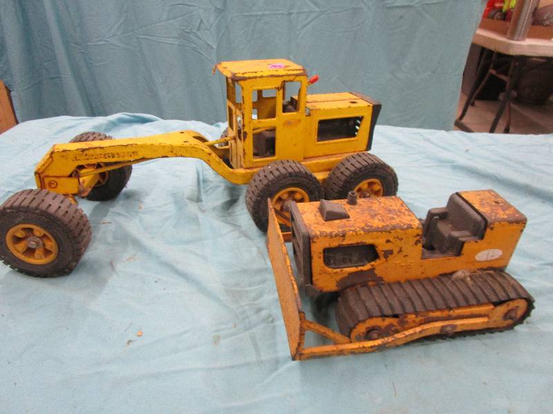 lot 195 image: Old Metal Toys and Milk Crate