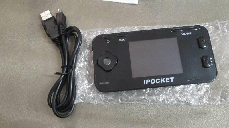 lot 101 image: iPocket Handheld Game Retail $49.99...