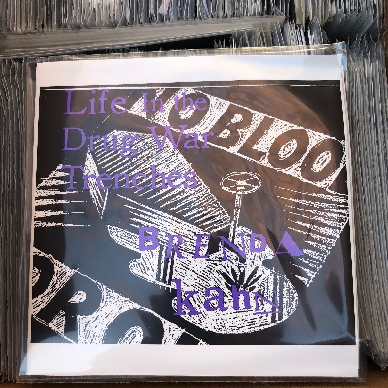 lot 303 image: Brenda Kahn  Life In The Drug War Trenches 7 Clear Vinyl ( LOT OF 200 )