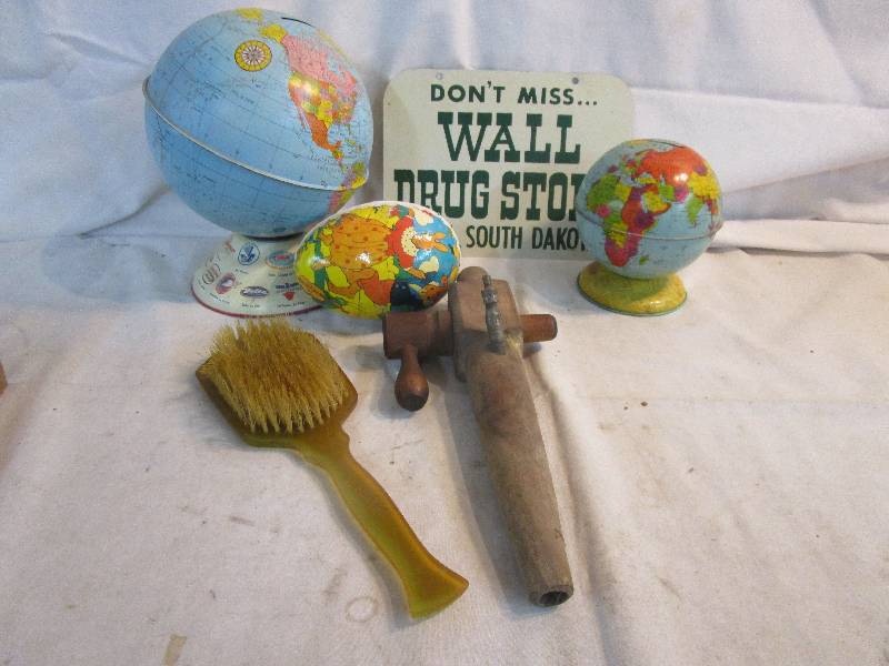 lot 183 image: Shrader Spicket, Metal Wall Drug Sign, 2 Metal Globes, Peter rabbit Egg and Old Dresser Brush