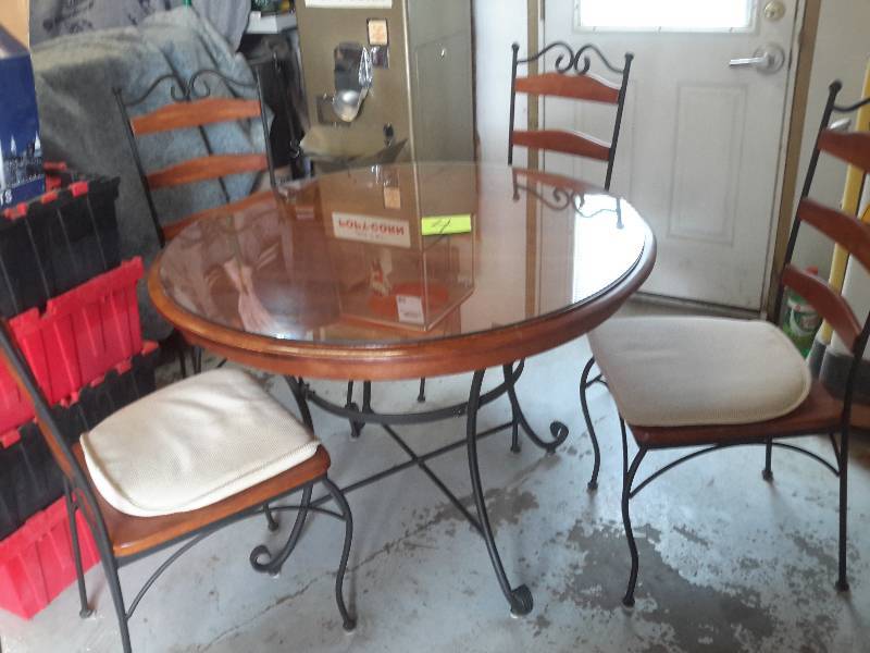 nice wrought iron base and chairs with nice wood top.. 42in diameter with glass top cover