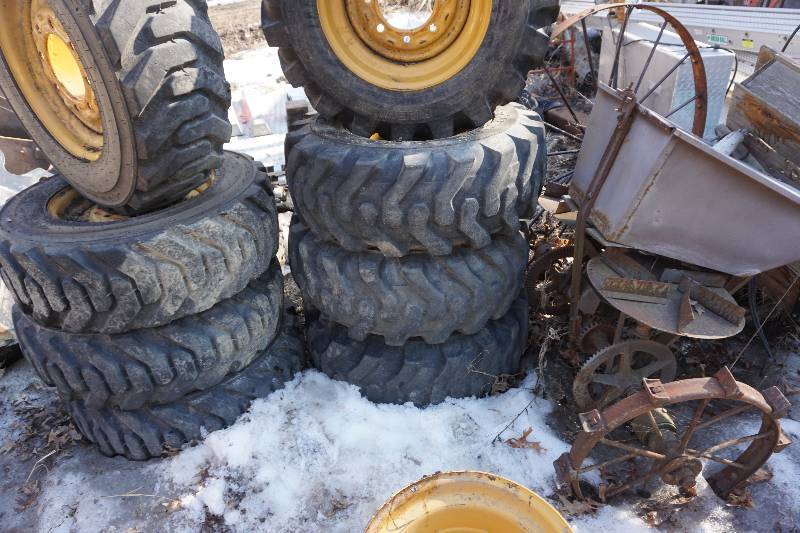 lot 22 image: Set of 4 - Akuret HD Side Wall 12 Ply Skid Loader Tires Mounted On Cat Rims