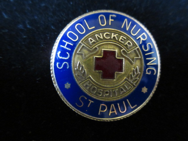 lot 333 image: 14K YG ST. PAUL NURSING COMMEMORATIVE PIN