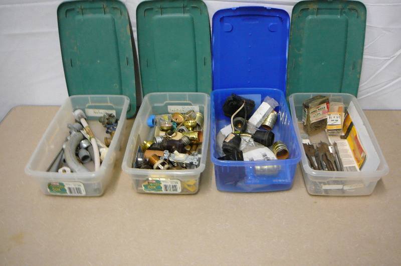lot 14 image: 12 Count Misc. sizes of boring bits, misc. light fixtures, switches, cover plates, misc. pluming supplies with totes