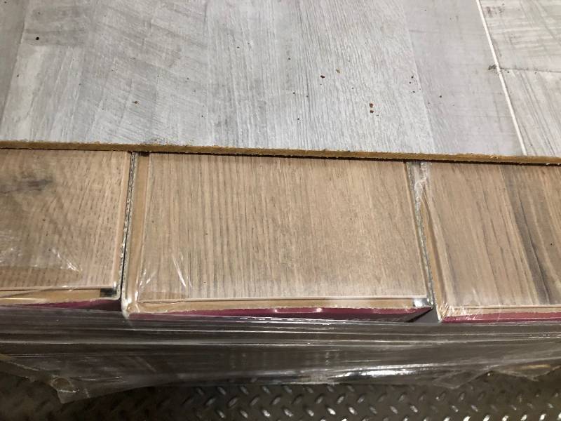 lot 21 image: LOT OF 2 PALLETS OF NEW Home Decorators Collection Kempson Ridge Oak 8 mm T x 6.26 in. W x 54.45 in. L Laminate Flooring (23.67 sq. ft.  case) 35 CASES FOR EACH PALLET