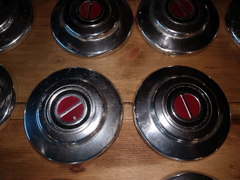 lot 20 image: Hub Caps (11), General Electric Sealed Beam Head Light, and Hex Nuts