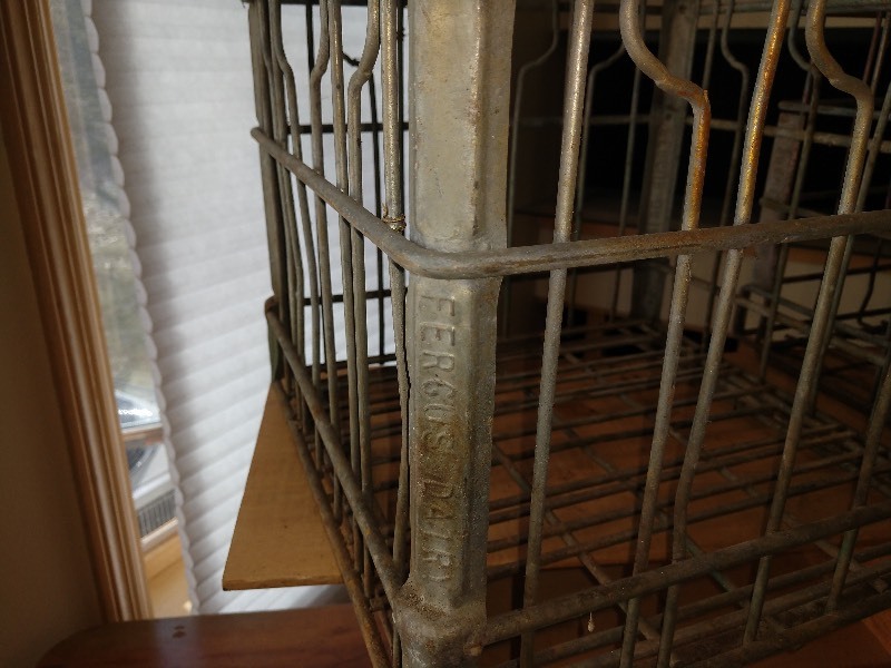 lot 50 image: Two Milk Crate Wire Baskets. Fergus Dairy and Home Town Dairy 1968