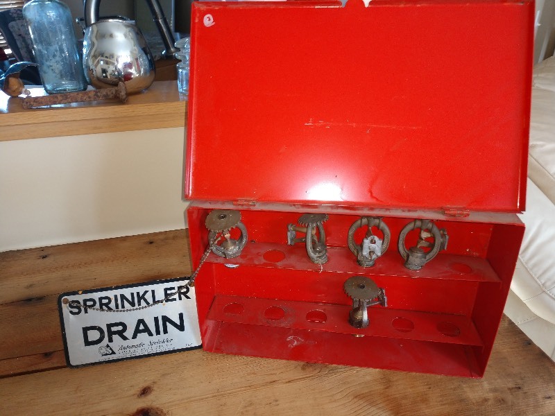 lot 55 image: Red Case Containing Sprinkler Heads and Sprinkler Drain Hang Sign