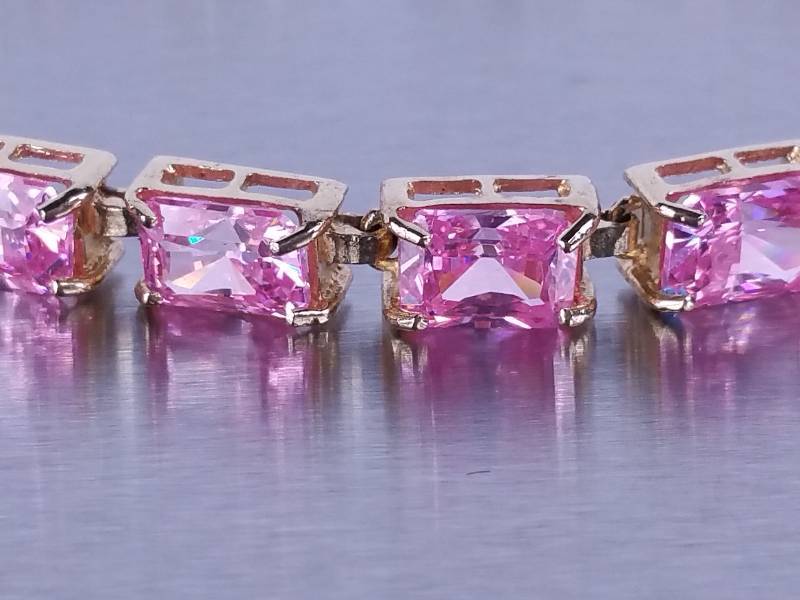 lot 19 image: 12ct Pink Sapphire Tennis Bracelet in Yellow Gold