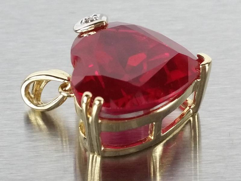 lot 60 image: 7ct Ruby and Diamond Pendant in Yellow Gold