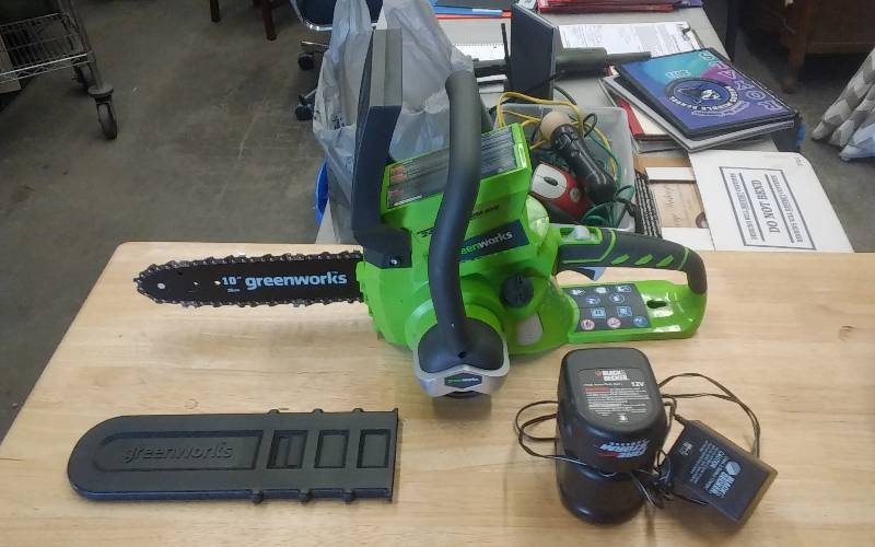 lot 25 image: Greenworks 10 Electric Chain Saw (No BatteryCharger), Black & Decker 12-V Battery & Charger