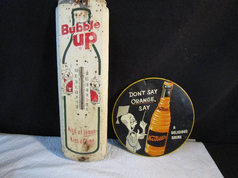 lot 26 image: Thermometer and advertising badge