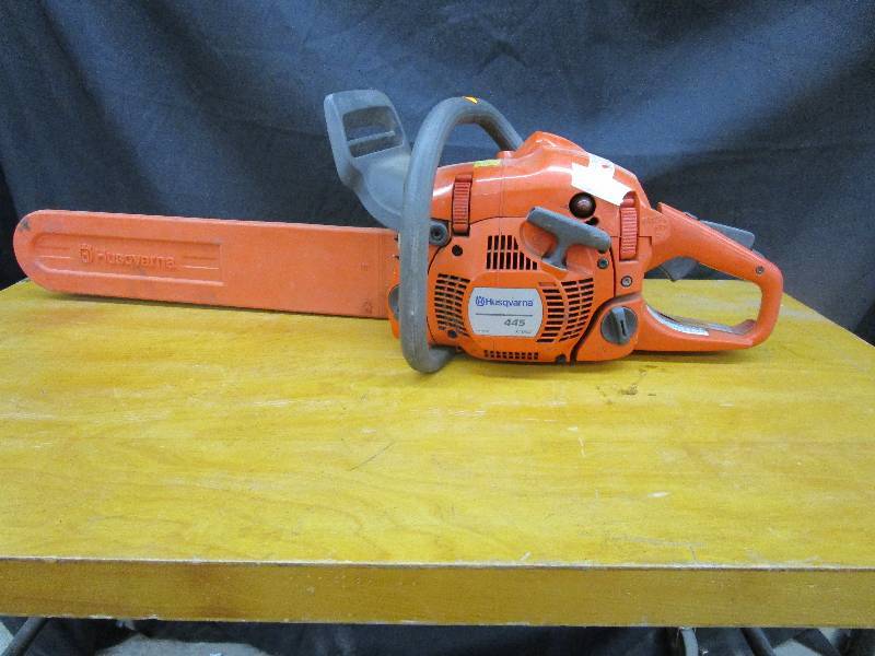 lot 78 image: Husqvarna 445 Chain Saw Starts an dRuns Leaks Gas has a Cracked Tank