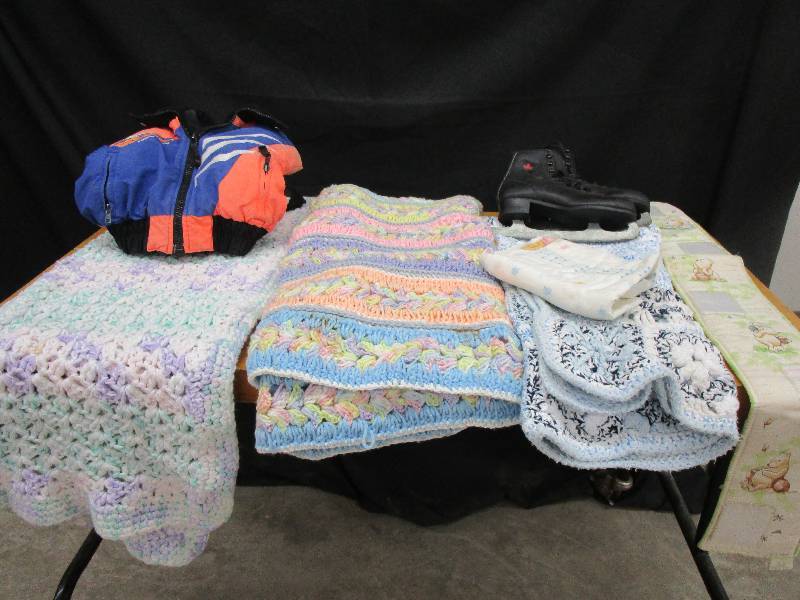 lot 82 image: Baby Blanket, Kids Iceskates, Polaris coat seem loose