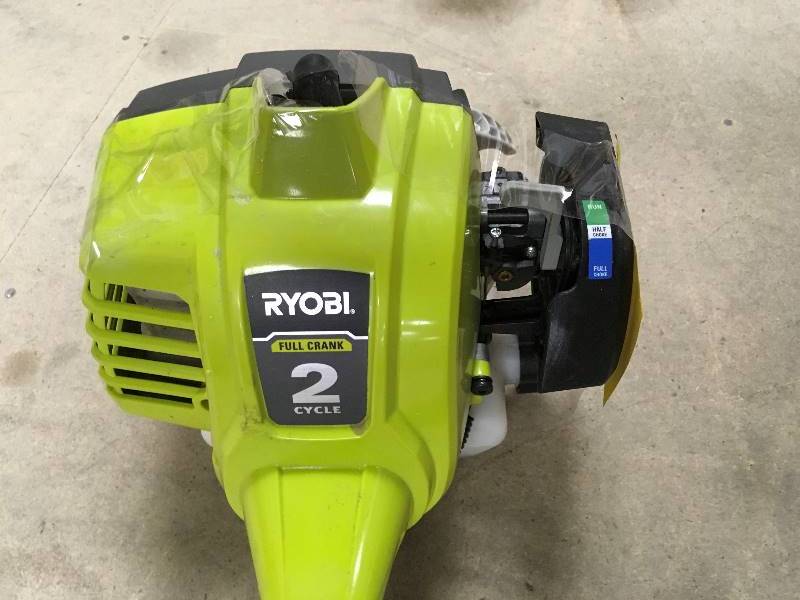 lot 41 image: Ryobi 25cc 2-Cycle Attachment Capable Full Crank Straight Gas Shaft String Trimmer using in working condition