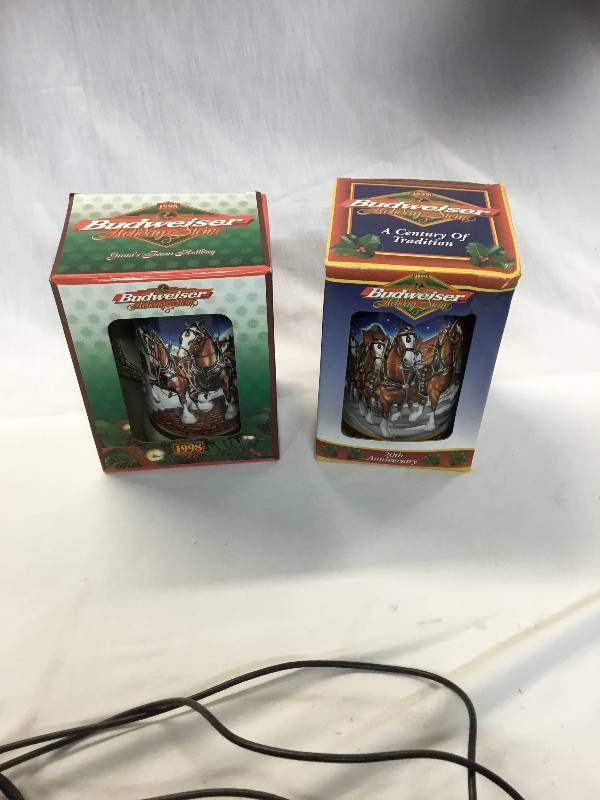 lot 74 image: 1998 and 1999 20th Anniversary Budweiser Holiday Stein in boxes.