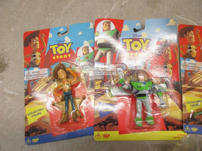 lot 21 image: Lot of Toy Story action Figures in Original Packaging , Woody and Buzz Dolls and Additional small toys in packaging