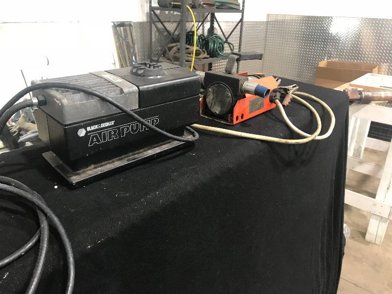 lot 112 image: Diesel fuel transfer pump and Black and Decker air pump.