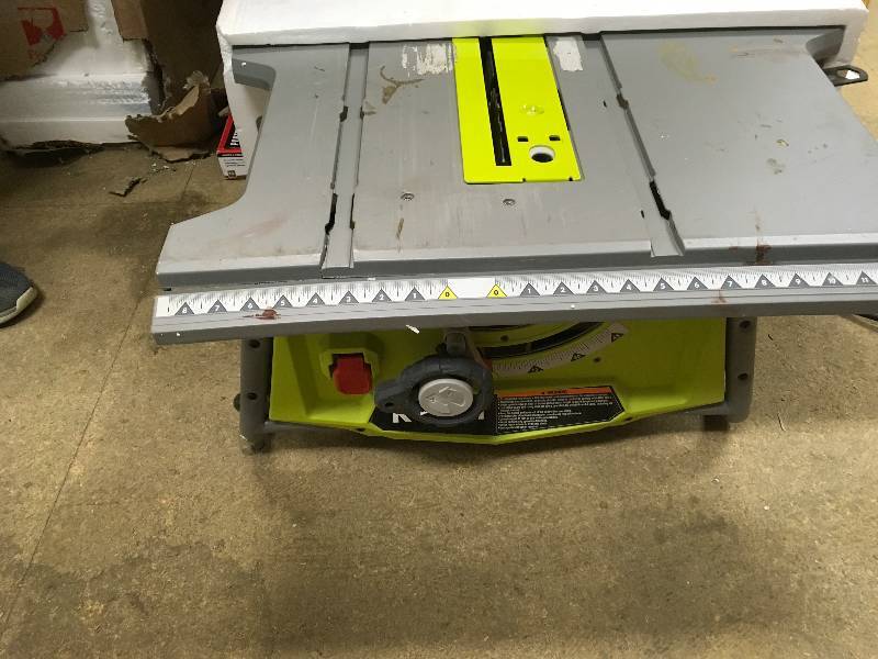 lot 29 image: Ryobi 10 table saw and folding stand in good condition missing rip Fence