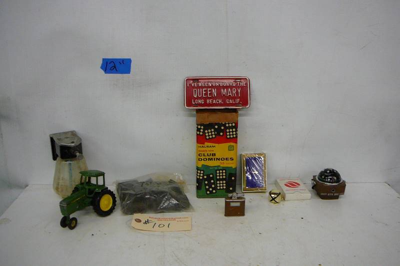 lot 101 image: Dominoes, Cards, Compass, Tractor wheel is broken, Hand soap dispenser, Lighter