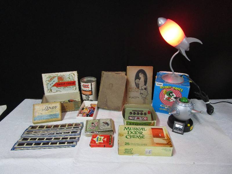 lot 96 image: Decks of cards, old dictionary, cartoon slides, poker game, musical door chime, looney tunes alarm clock