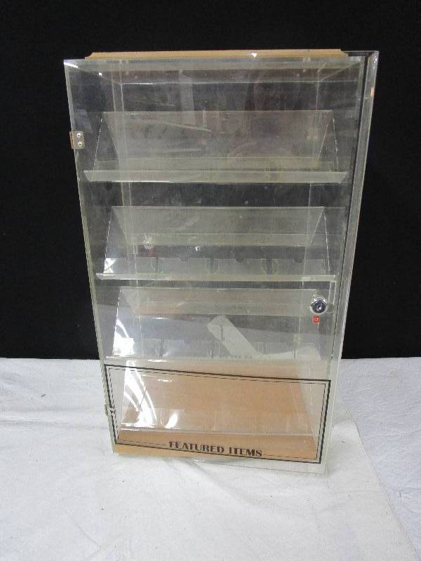 lot 105 image: Plastic display case, there is a key, doors on both sides. 22.5 high 9.5 wide and 13 long
