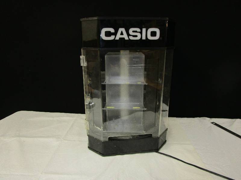 lot 106 image: Casio Display Case, Round, Turns 23.5 High and 16.5 wide. There is a key