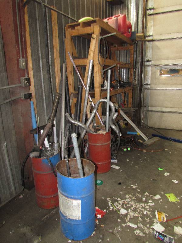 lot 123 image: CONTENTS OF SHELF, BARRELS, PIPE, GAS CANS