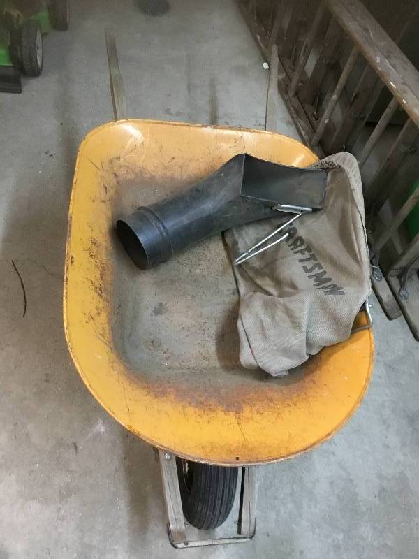 lot 45 image: Yellow Steel Wheel Barrow with a Craftsman Bag and Chute