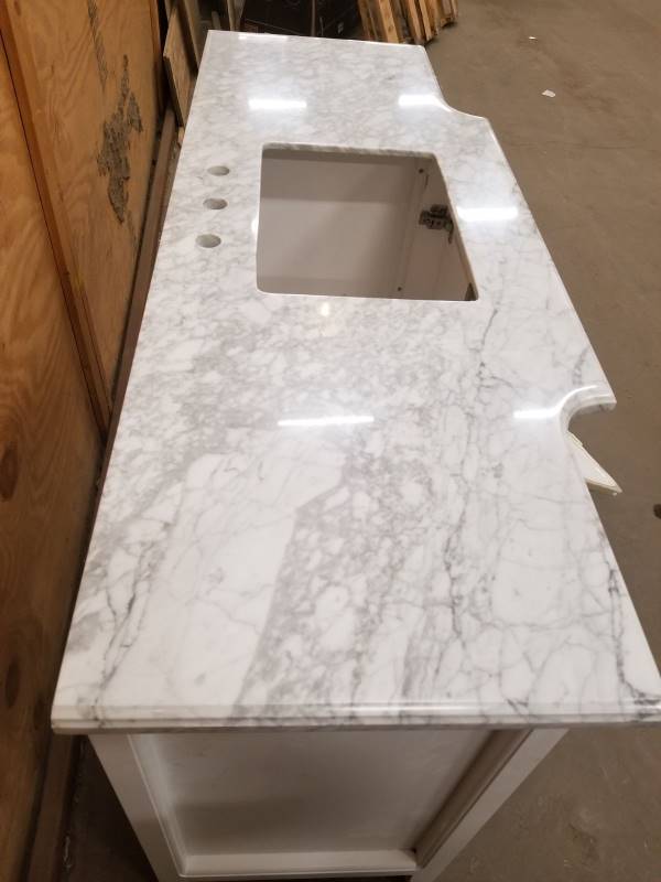 lot 105 image: Sassy 60 in. Vanity in White with Marble Vanity Top in Carrara White whit damage on the vanity display photo asre used to display the unit