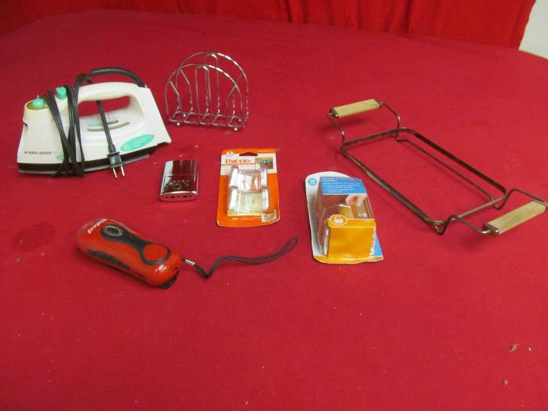 lot 23 image: Black and Decker iron, vintage hand warmer, safety latches, napkin holder, casserole stand