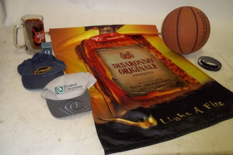 lot 72 image: 2 hats, basketball, mug, stamp dispenser, small beltstrap, hanging banner