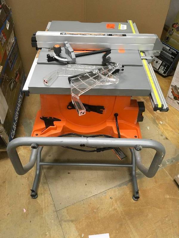 lot 66 image: RIDGID 15 Amp 10 in. Heavy-Duty Portable Table Saw with Stand in like new condition