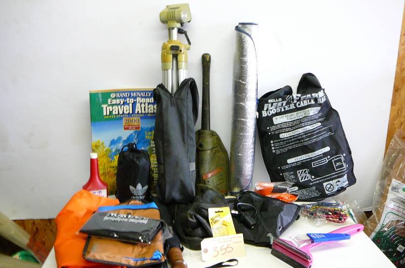 lot 355 image: Military shovel, jumper cables, 2 umbrellas, atlas, tarp, emergency ponchos, camera tripod and camera case, bungee, cards, car window shade actions packer Rubbermaid tote
