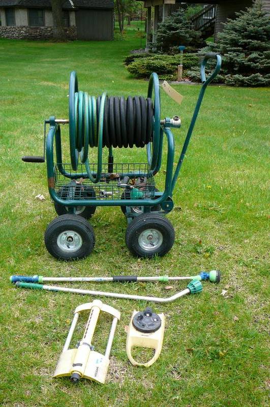 lot 450 image: garden hose reel  on cart with watering nozzles, sprinkler heads
