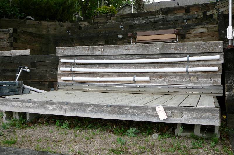 lot 511 image: Shore Station sectional dock with aluminum top 40 long with L patio. L Patio is 92 x 96 and 45corner with boat bumpers canoe kayak holder