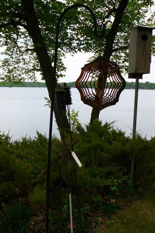 lot 515 image: 3 decorative tiki torches, 1 Sheepers hook with deer wind chime, 1 metal yard decoration