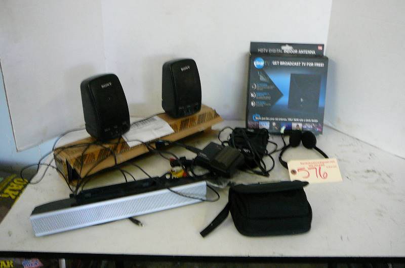 lot 576 image: GPS, TV satellite sound bar, sonny computer speakers, canon battery charger, headphones, Garmin speaker