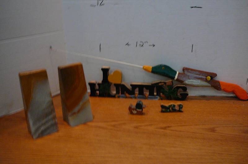 lot 884 image: Home decor marble bookends, mallard ice fishing pole, knickknacks