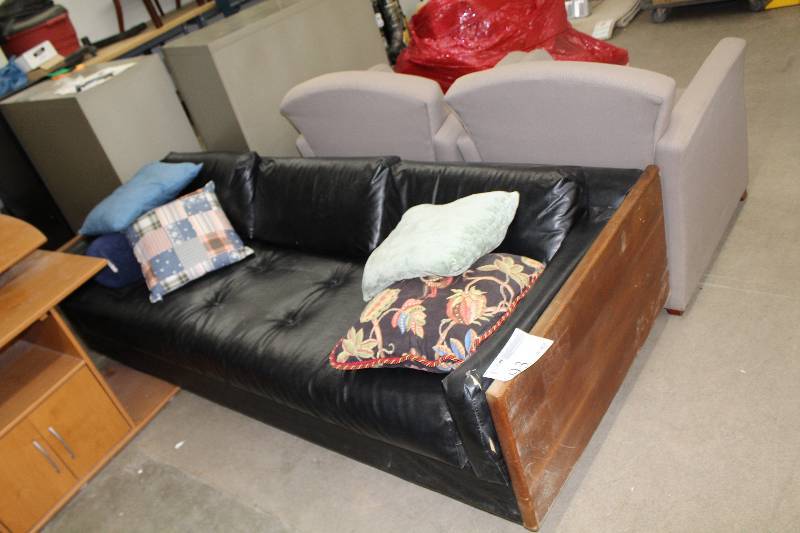 lot 93 image: Black leather sofa with wood end cap