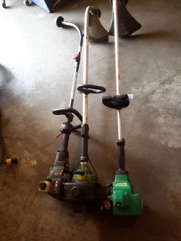 lot 134 image: 3 motorized trimmers.. These need carb work Untested
