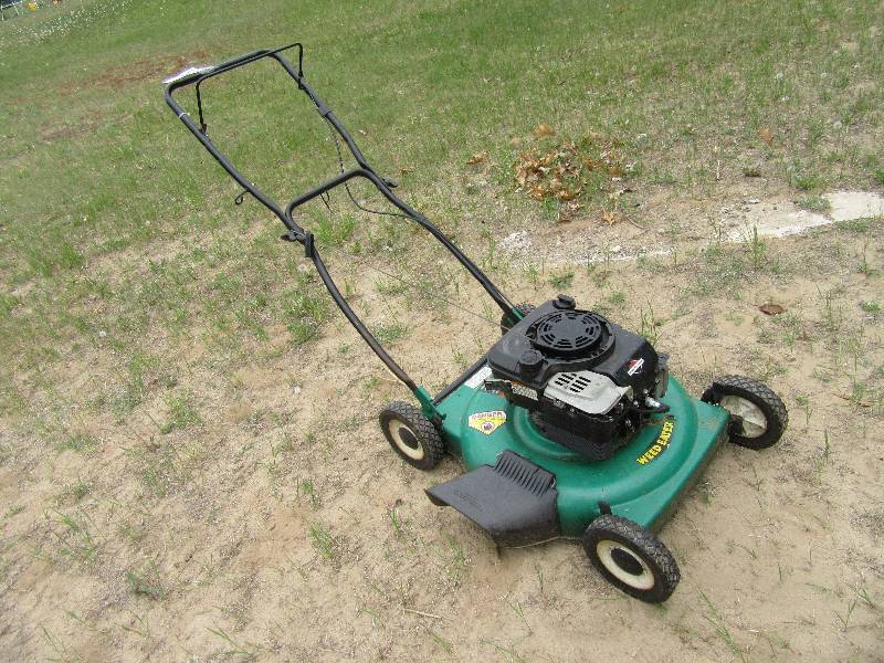 lot 22 image: Pouland Weed Eater mower.