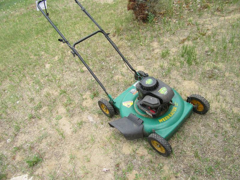 lot 20 image: Pouland Weed Eater mower.