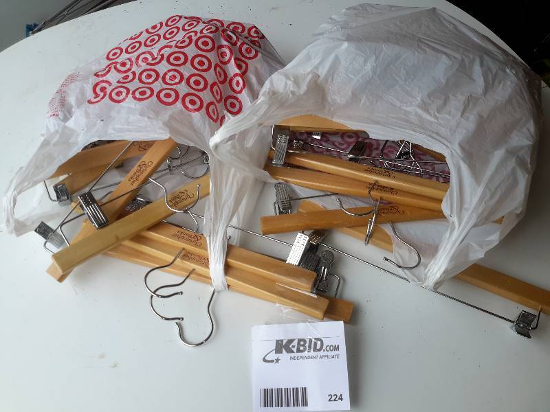 lot 224 image: 2 bags of slacks hanging hangers.. Made from wood